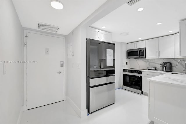 3015 N Ocean Blvd Unit 4K, Fort Lauderdale, FL 33308 - kitchen featuring stainless steel appliances, white cabinetry, recessed lighting, a sink, and baseboards