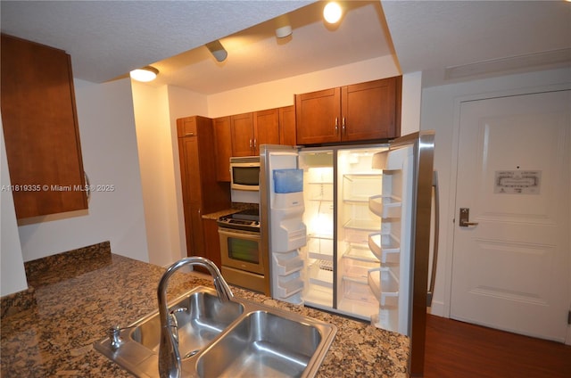 400 N Federal Hwy Unit 302S, Boynton Beach, FL 33435 - kitchen featuring a sink, stainless steel range, white microwave, brown cabinets, and dark wood-style flooring