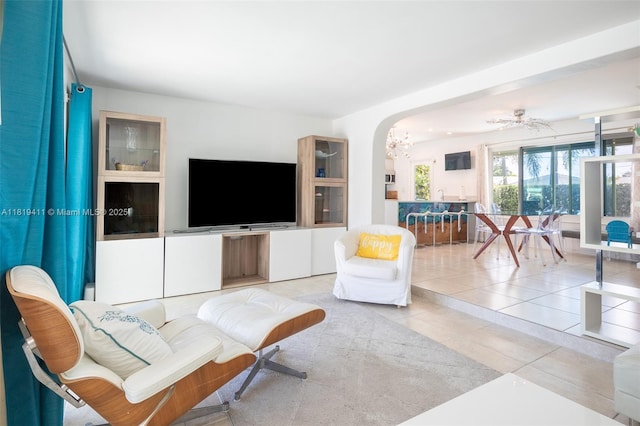 806 Argonaut Is, Dania Beach, FL 33004 - living room with tile patterned floors, arched walkways, and a chandelier