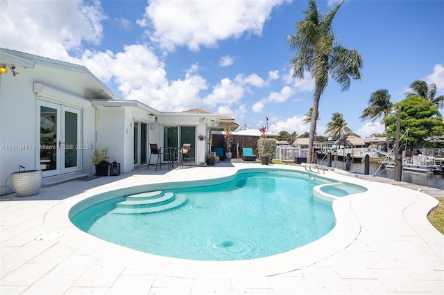 806 Argonaut Is, Dania Beach, FL 33004 - view of pool with french doors, a patio area, a pool with connected hot tub, and a water view