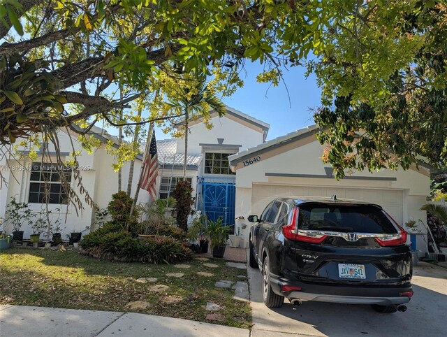15640 SW 98th St, Miami, FL 33196 - view of front facade with stucco siding and an attached garage