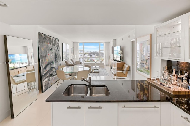 6801 Collins Ave Unit 1401, Door Number Miami Beach, FL 33141 - kitchen with a sink, open floor plan, white cabinets, and light tile patterned floors