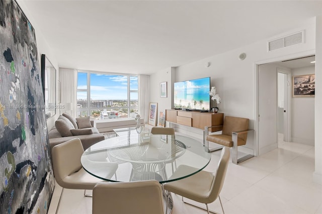 6801 Collins Ave Unit 1401, Door Number Miami Beach, FL 33141 - dining room featuring floor to ceiling windows and light tile patterned floors