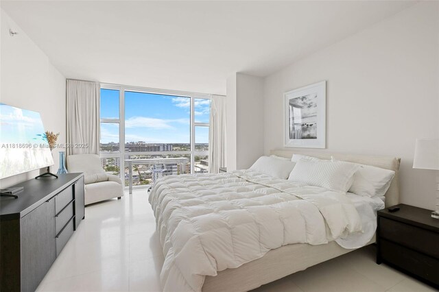 6801 Collins Ave Unit 1401, Door Number Miami Beach, FL 33141 - bedroom with a wall of windows and light tile patterned floors