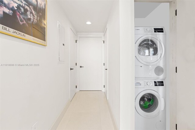 6801 Collins Ave Unit 1401, Door Number Miami Beach, FL 33141 - laundry area featuring estacked washer and dryer, baseboards, recessed lighting, and tile patterned floors