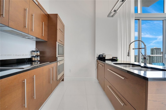 485 Brickell Ave Unit 4004, Miami, FL 33131 - kitchen with wall oven, dark countertops, and brown cabinets