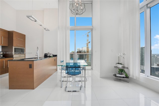 485 Brickell Ave Unit 4004, Miami, FL 33131 - dining space with a towering ceiling, tile patterned floors, and a chandelier