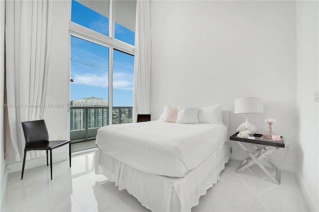 485 Brickell Ave Unit 4004, Miami, FL 33131 - bedroom with light tile patterned floors, expansive windows, and access to outside