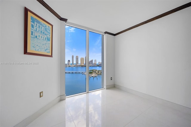 3201 NE 183rd St Unit 1702, Aventura, FL 33160 - tiled empty room with ornamental molding, floor to ceiling windows, baseboards, a view of skyline, and a water view