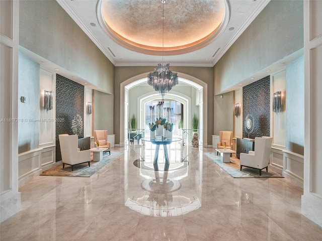 3201 NE 183rd St Unit 1702, Aventura, FL 33160 - building lobby with a decorative wall, a towering ceiling, and crown molding