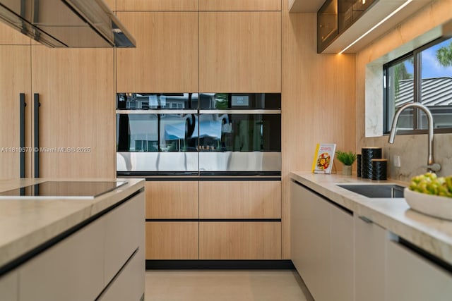 2033 NE 22nd St, Wilton Manors, FL 33305 - kitchen with a sink, black electric stovetop, oven, and light countertops