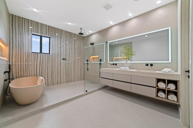 2033 NE 22nd St, Wilton Manors, FL 33305 - full bathroom featuring a walk in shower, double vanity, a soaking tub, and recessed lighting