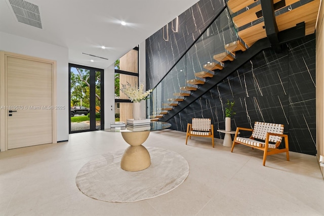 2033 NE 22nd St, Wilton Manors, FL 33305 - entrance foyer with floor to ceiling windows, stairway, recessed lighting, and a towering ceiling