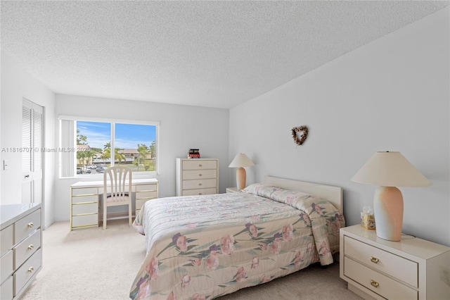 311 Pine Ridge Cir Unit C-2, Green Acres, FL 33463 - bedroom with light colored carpet and a textured ceiling