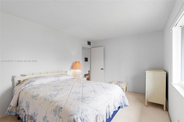 311 Pine Ridge Cir Unit C-2, Green Acres, FL 33463 - bedroom featuring light carpet, a textured ceiling, and baseboards