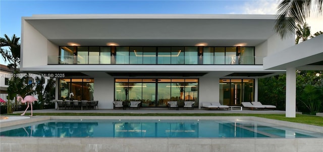 375 N Hibiscus Dr, Miami Beach, FL 33139 - rear view of property with a balcony, a patio area, an outdoor pool, and outdoor lounge area