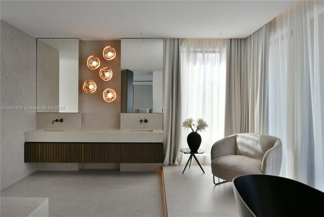 375 N Hibiscus Dr, Miami Beach, FL 33139 - bathroom with double vanity, a soaking tub, and backsplash