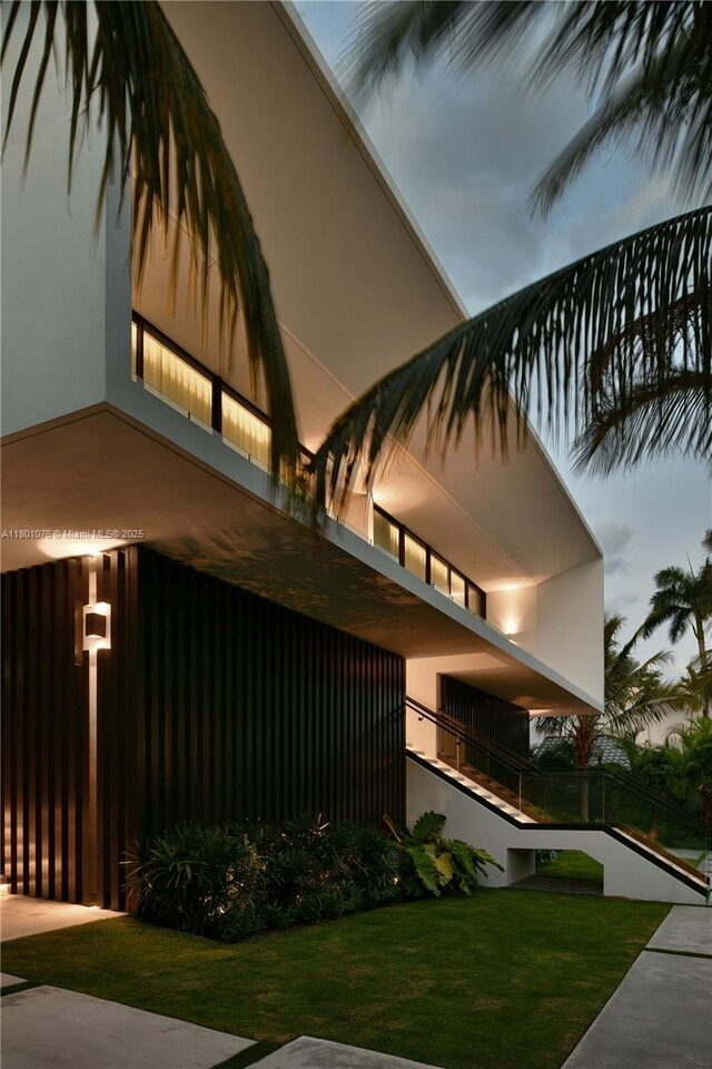 375 N Hibiscus Dr, Miami Beach, FL 33139 - view of home's exterior featuring stucco siding, a yard, and a balcony