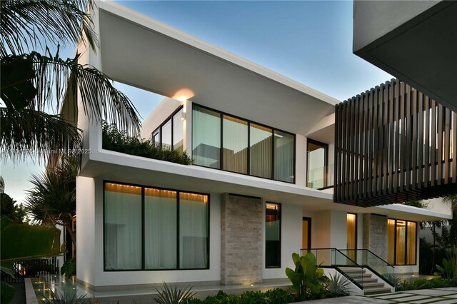 375 N Hibiscus Dr, Miami Beach, FL 33139 - rear view of property with a balcony and stucco siding