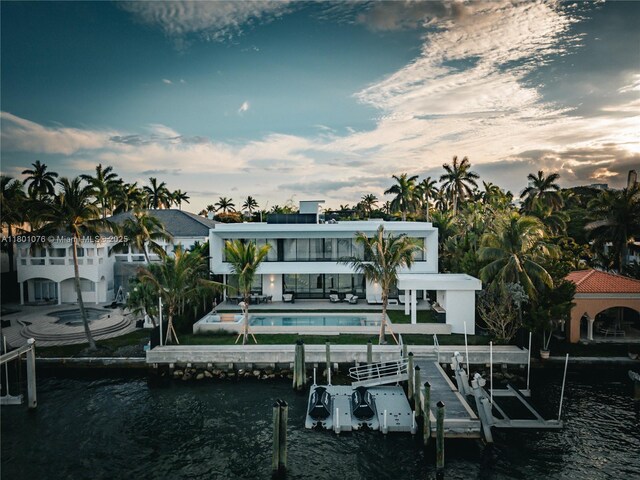 375 N Hibiscus Dr, Miami Beach, FL 33139 - dock area with boat lift, a water view, an outdoor pool, and a patio area