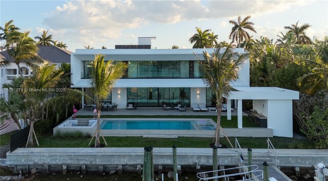 375 N Hibiscus Dr, Miami Beach, FL 33139 - back of house with an outdoor hangout area, a patio area, an outdoor pool, boat lift, and a balcony