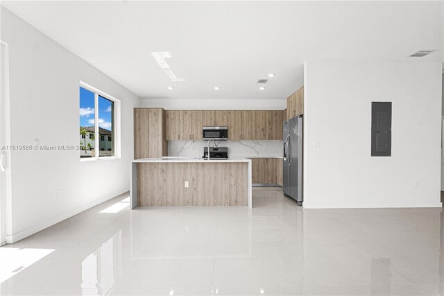 19446 SW 296th St Unit A, Homestead, FL 33030 - kitchen featuring electric panel, modern cabinets, stainless steel appliances, light countertops, and brown cabinetry