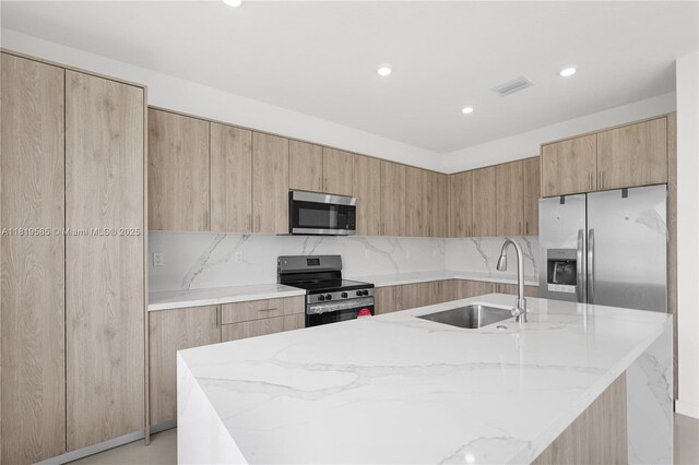 19446 SW 296th St Unit A, Homestead, FL 33030 - kitchen with appliances with stainless steel finishes, a sink, light stone countertops, modern cabinets, and tasteful backsplash