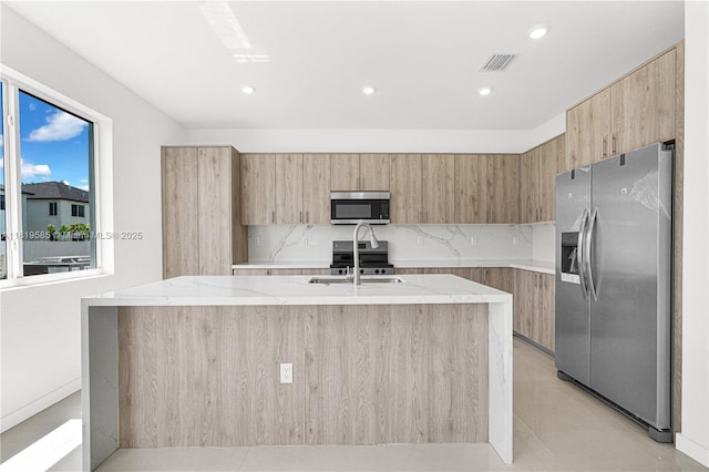 19446 SW 296th St Unit A, Homestead, FL 33030 - kitchen with stainless steel appliances, modern cabinets, light stone countertops, backsplash, and an island with sink