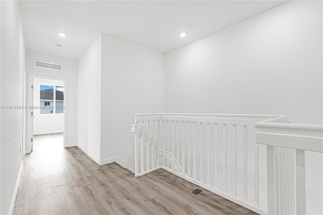 19446 SW 296th St Unit A, Homestead, FL 33030 - corridor featuring wood finished floors, an upstairs landing, baseboards, recessed lighting, and radiator heating unit