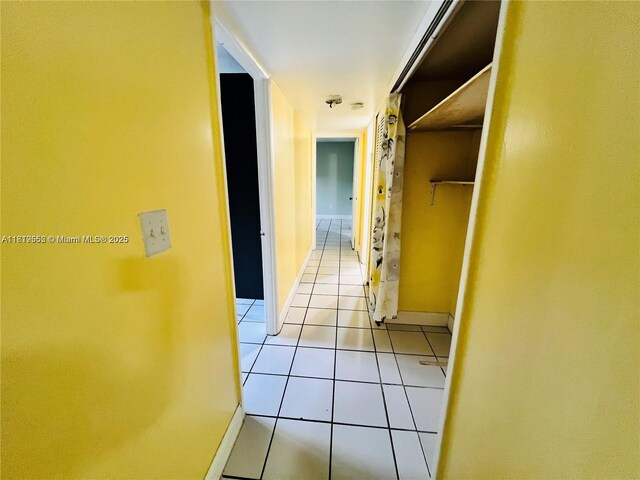 8511 NW 8th St Unit 103, Miami, FL 33126 - corridor featuring light tile patterned flooring and baseboards