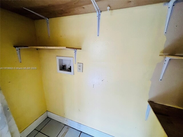 8511 NW 8th St Unit 103, Miami, FL 33126 - laundry room featuring washer hookup, tile patterned floors, baseboards, and a garage