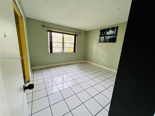 8511 NW 8th St Unit 103, Miami, FL 33126 - empty room with light tile patterned floors and baseboards