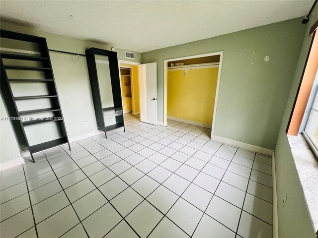 8511 NW 8th St Unit 103, Miami, FL 33126 - unfurnished bedroom featuring baseboards and light tile patterned floors