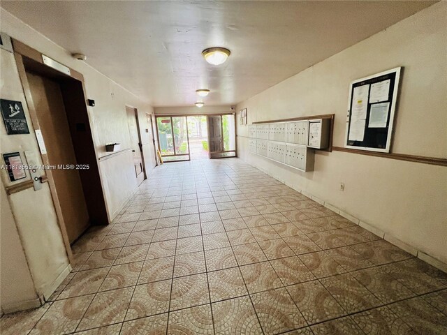 8511 NW 8th St Unit 103, Miami, FL 33126 - hallway with mail area, baseboards, and tile patterned floors