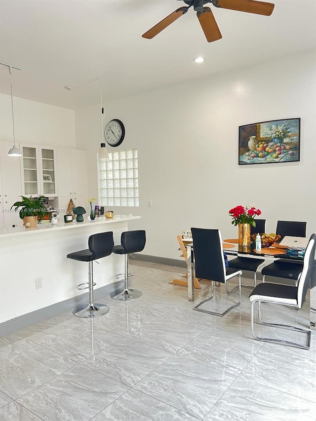 1120 Papaya St, Hollywood, FL 33019 - dining room featuring a ceiling fan, baseboards, light marble finish flooring, and recessed lighting