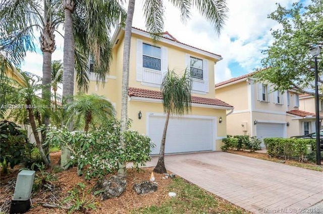 1120 Papaya St, Hollywood, FL 33019 - mediterranean / spanish-style home featuring a tiled roof, a garage, decorative driveway, and stucco siding