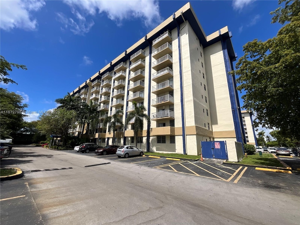 4550 NW 9th St Unit 118E, Miami, FL 33126 - view of apartment building / complex featuring uncovered parking