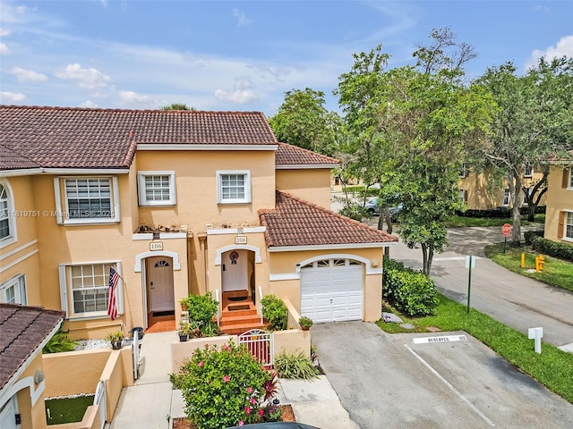 14621 Balgowan Rd Unit 206-3, Miami Lakes, FL 33016 - view of front of home with a tiled roof, stucco siding, and uncovered parking