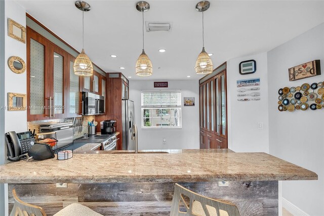 14621 Balgowan Rd Unit 206-3, Miami Lakes, FL 33016 - kitchen with appliances with stainless steel finishes, glass insert cabinets, a peninsula, recessed lighting, and a kitchen breakfast bar