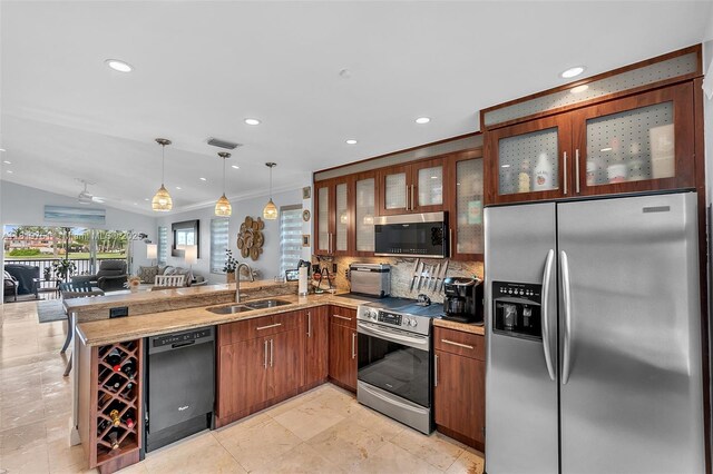 14621 Balgowan Rd Unit 206-3, Miami Lakes, FL 33016 - kitchen with appliances with stainless steel finishes, a peninsula, open floor plan, brown cabinets, and tasteful backsplash