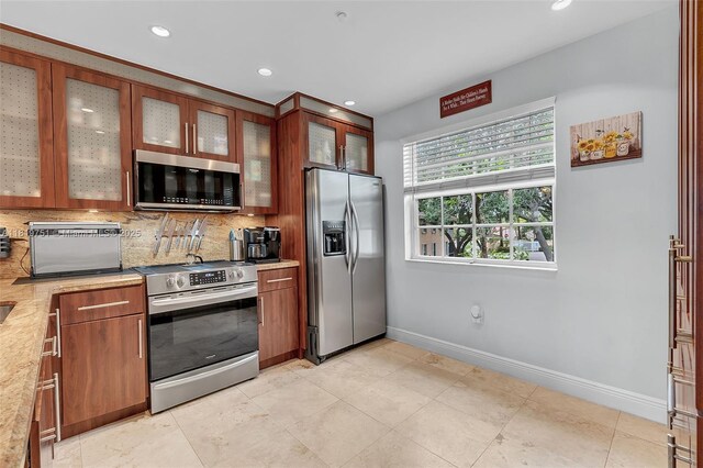14621 Balgowan Rd Unit 206-3, Miami Lakes, FL 33016 - kitchen with stainless steel appliances, light countertops, tasteful backsplash, recessed lighting, and brown cabinetry
