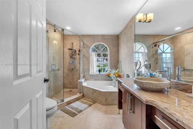 14621 Balgowan Rd Unit 206-3, Miami Lakes, FL 33016 - full bath featuring vanity, a garden tub, a stall shower, tile patterned floors, and tile walls