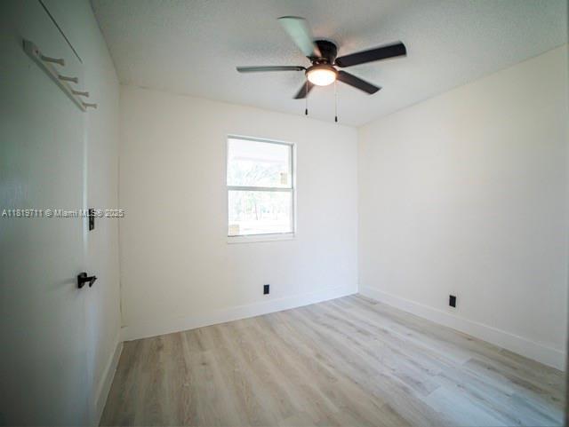 412 Columbus Pkwy, Hollywood, FL 33021 - spare room with light wood finished floors, a ceiling fan, and baseboards