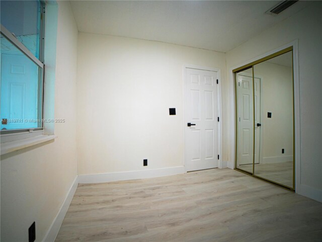 412 Columbus Pkwy, Hollywood, FL 33021 - laundry room featuring light wood-style floors and baseboards