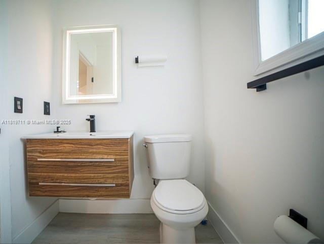 412 Columbus Pkwy, Hollywood, FL 33021 - bathroom featuring toilet, baseboards, vanity, and wood finished floors
