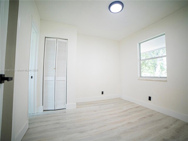 412 Columbus Pkwy, Hollywood, FL 33021 - unfurnished bedroom with light wood-type flooring, baseboards, and a closet
