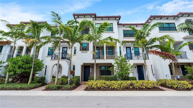 11530 SW 13th Ct, Pembroke Pines, FL 33025 - view of front of home featuring stucco siding, a balcony, and a tiled roof