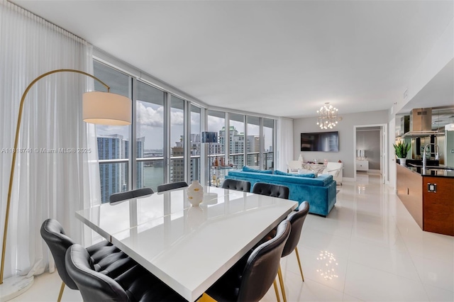 495 Brickell Ave Unit 3604, Miami, FL 33131 - dining room with a chandelier, light tile patterned flooring, and baseboards