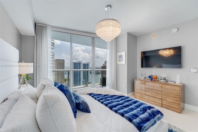 495 Brickell Ave Unit 3604, Miami, FL 33131 - bedroom featuring a chandelier, baseboards, and expansive windows