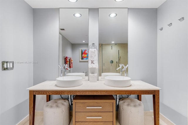 495 Brickell Ave Unit 3604, Miami, FL 33131 - bathroom featuring a shower stall, double vanity, baseboards, and recessed lighting